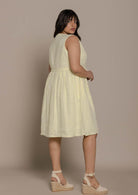 functional yellow sleeveless dress with a drawstring on the waist to give it more definition. 