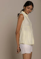 yellow sleeveless collared top with a hidden placket lends a sleek look to this classic top.