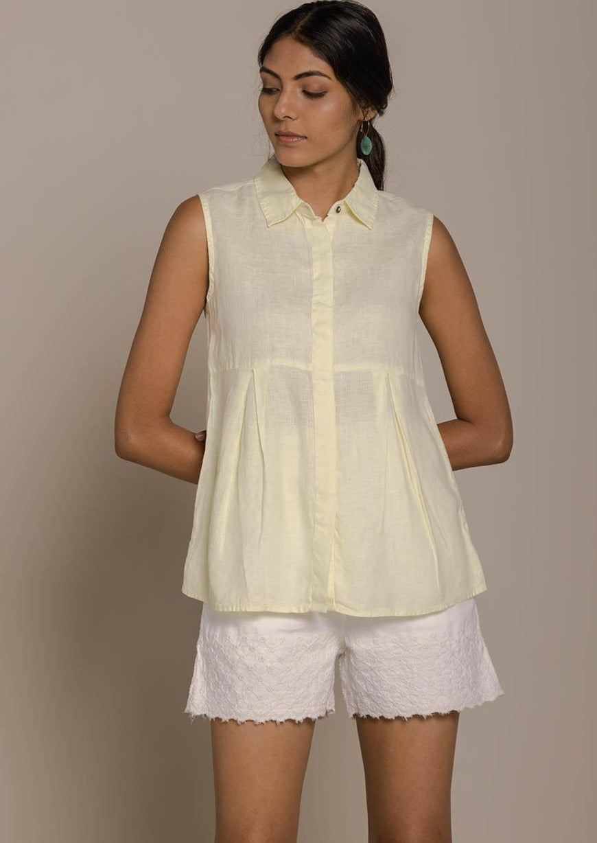 yellow sleeveless collared top with a hidden placket lends a sleek look to this classic top.