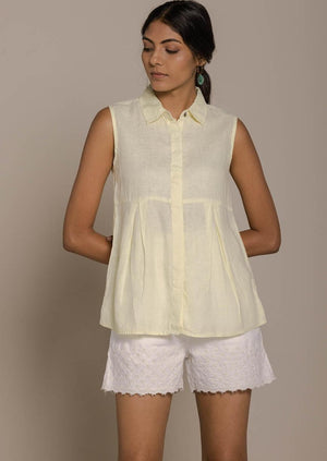 yellow sleeveless collared top with a hidden placket lends a sleek look to this classic top.