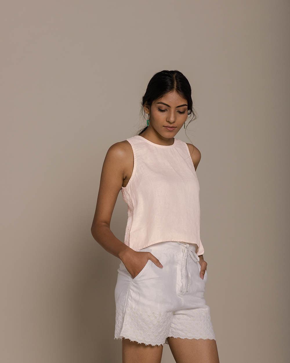 blush pink camisole top with embroidery on the back and brown buttoned details 