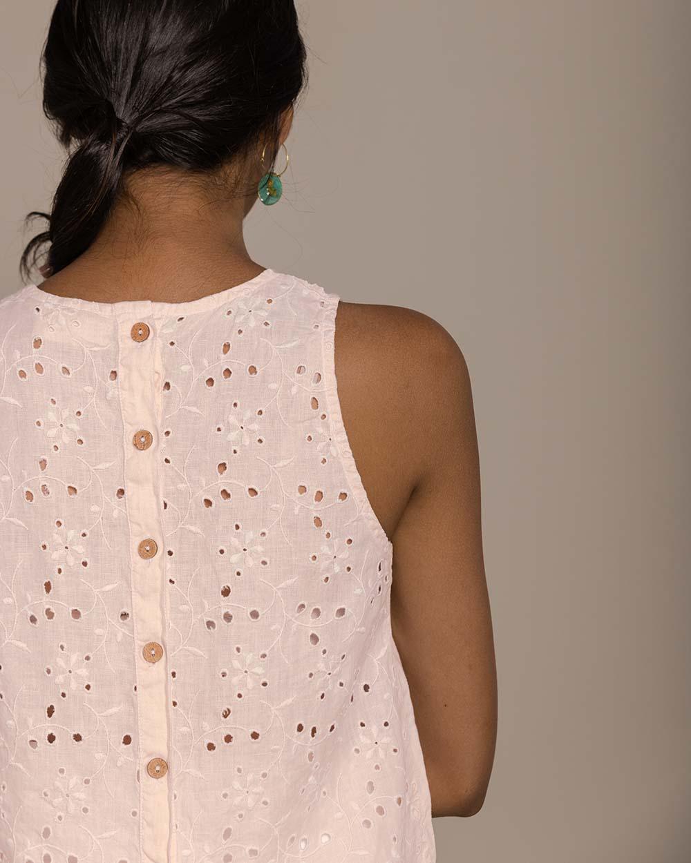 blush pink camisole top with embroidery on the back and brown buttoned details 