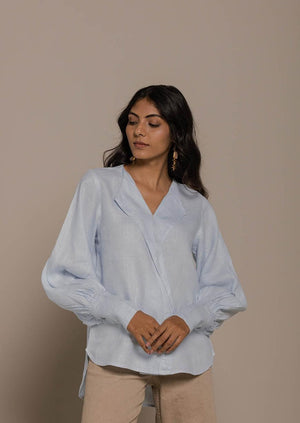 blue vintage shirt with an overlapped collar and balloon sleeves with buttoned wrists