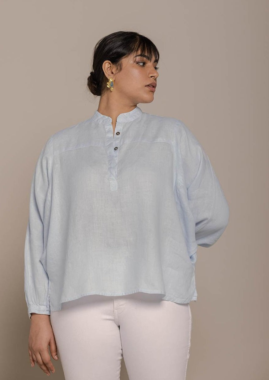 Blue top with flowy butterfly sleeves and a mandarin or Chinese collar