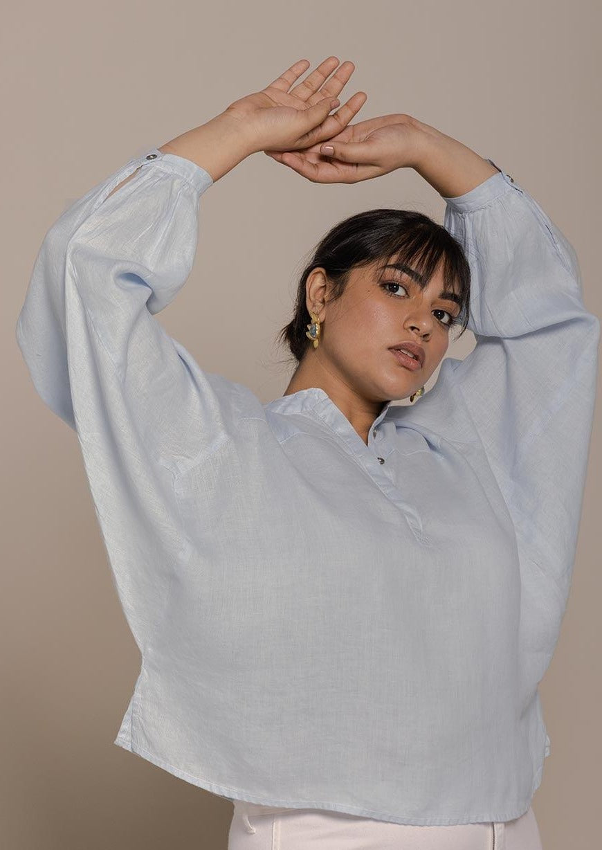 Blue top with flowy butterfly sleeves and a mandarin or Chinese collar