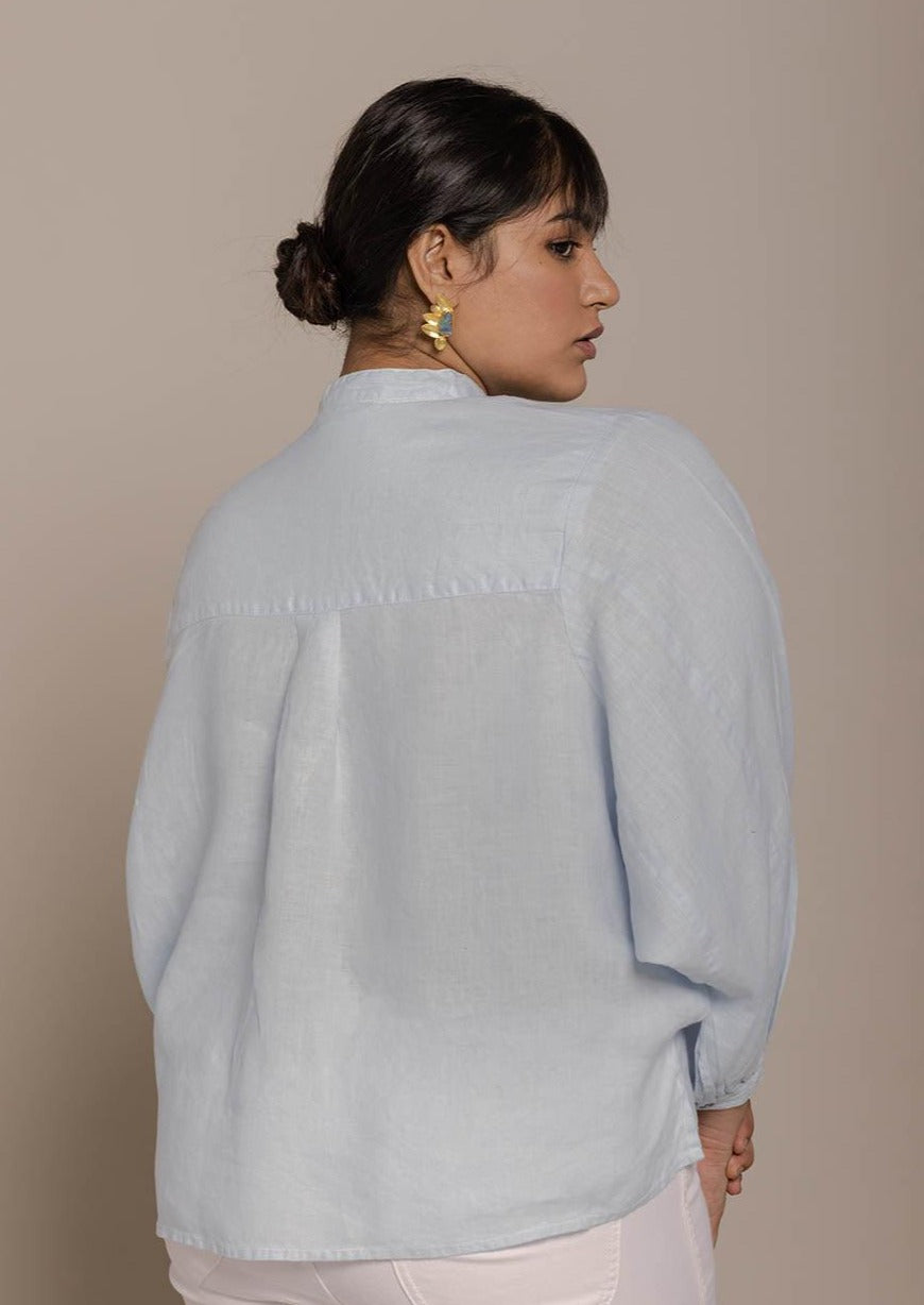 Blue top with flowy butterfly sleeves and a mandarin or Chinese collar