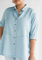 Close-up of the Reistor Ready for the World Shirt in Blue Denim, featuring a button-front design, rolled sleeves and lightweight denim fabric for everyday wear.