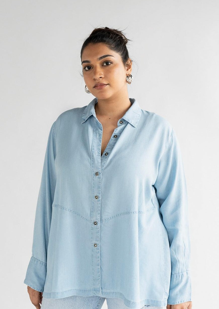 Model wearing the Reistor Ready for the World Shirt in Blue Denim, showcasing a relaxed silhouette, soft breathable denim and timeless everyday style.