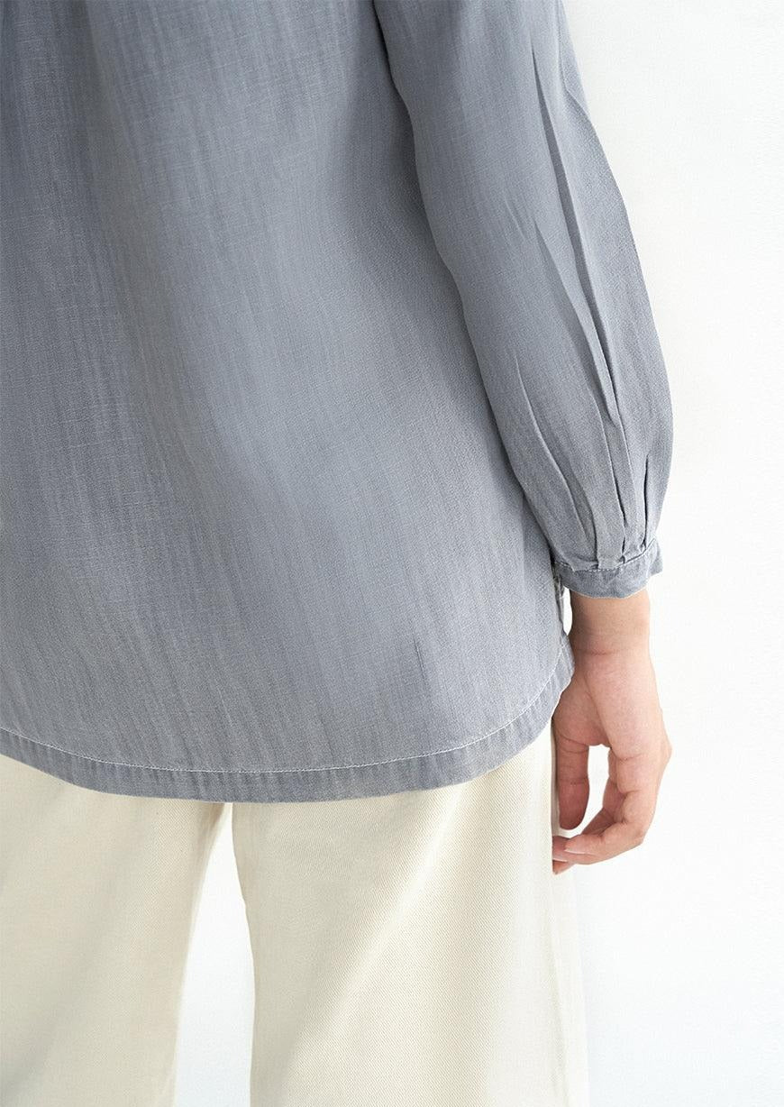 Reistor Shades of Everyday Top in Stone Grey showcasing the back hem and sleeve detail, crafted from breathable lightweight fabric for lasting comfort.