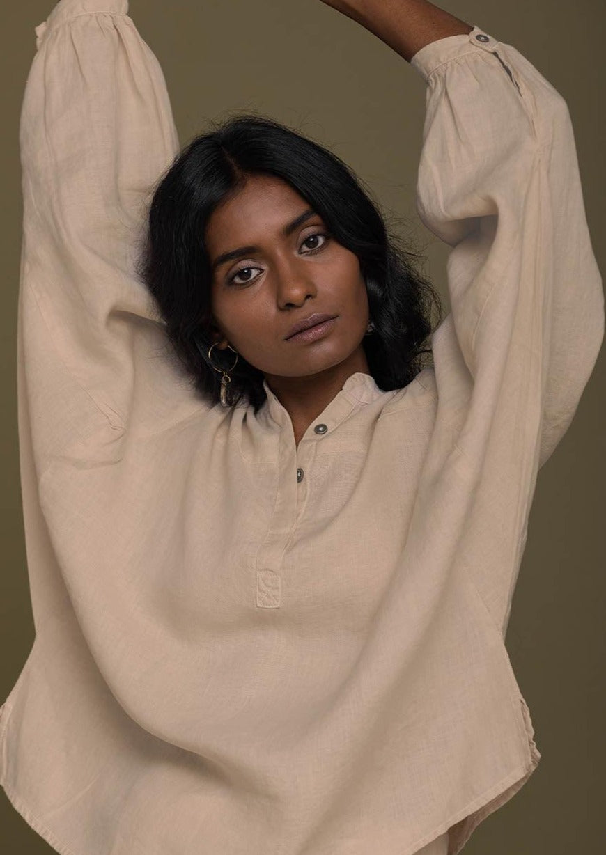 Beige top with flowy butterfly sleeves and a mandarin or Chinese collar