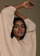 Beige top with flowy butterfly sleeves and a mandarin or Chinese collar