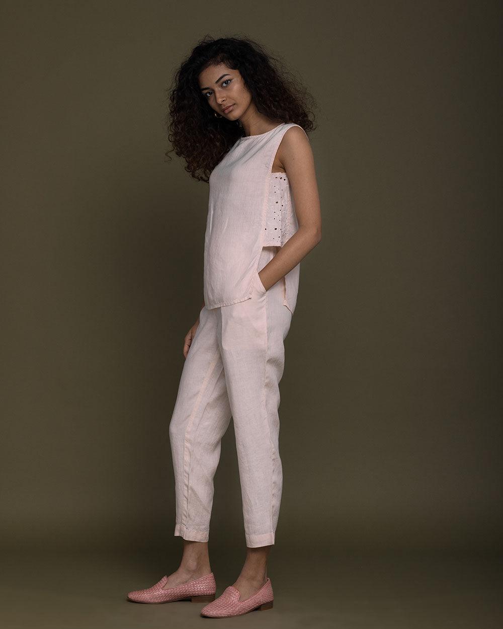 pastel pink sleeveless top with embroidered detailing on the sides. Reistor