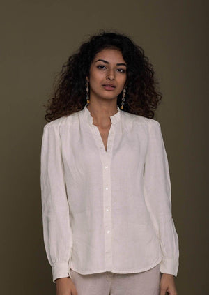 off white pleated button-down shirt with shoulder pads for added structure.