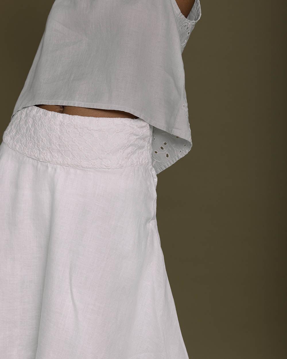 white straight comfort-fit skirt with an embroidered belt to accentuate the waistline.