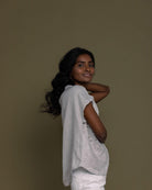 cloud grey embroidered top with side pockets.
