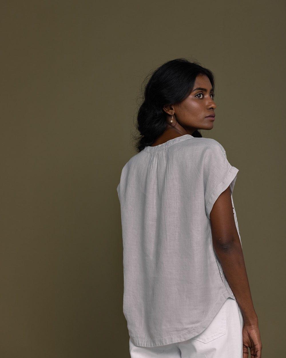 cloud grey embroidered top with side pockets.