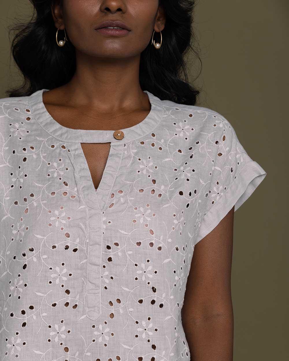 cloud grey embroidered top with side pockets.