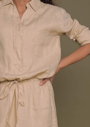 beige collared shirt dress with full sleeves and a drawstring at the waist