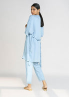 Back view of the Reistor Wrapped in Happiness Overlay in Ocean Blue, featuring a flowing silhouette, lightweight fabric and relaxed layering style.