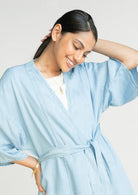 Close-up of the Reistor Wrapped in Happiness Overlay in Ocean Blue with a flattering V-neckline, kimono sleeves and breathable lightweight fabric.