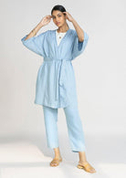 Full-length view of the Reistor Wrapped in Happiness Overlay in Ocean Blue, featuring a tie-waist design, relaxed kimono sleeves and lightweight fabric.